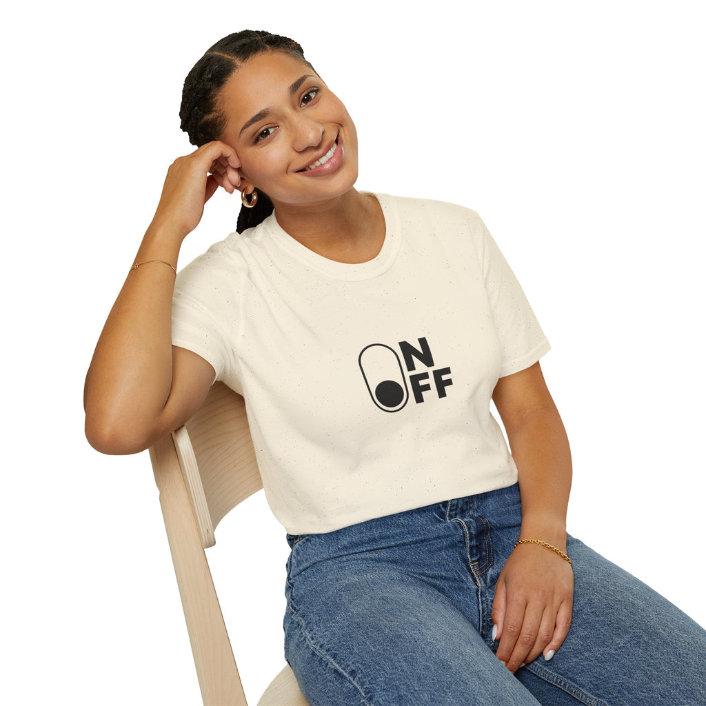 Woman wearing a natural-colour On/Off graphic T-shirt with jeans, seated on a chair.