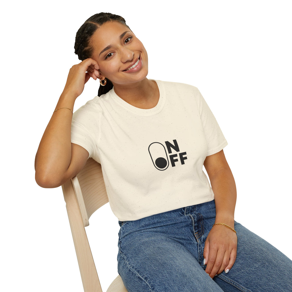 Woman wearing a natural-colour On/Off graphic T-shirt with jeans, seated on a chair.