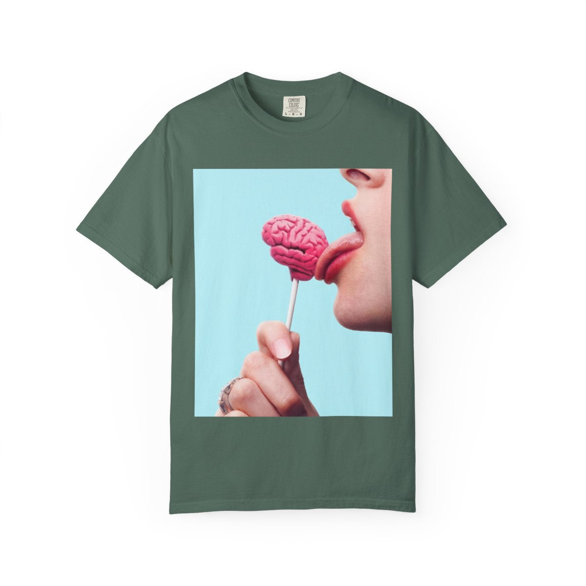 Lickin Brain T-Shirt in Blue Spruce with a surreal print of a tongue licking a pink brain lollipop against a turquoise background.