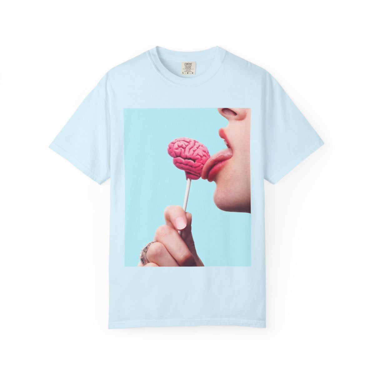 Lickin Brain T-Shirt in Chambray with a surreal print of a tongue licking a pink brain lollipop against a turquoise background.