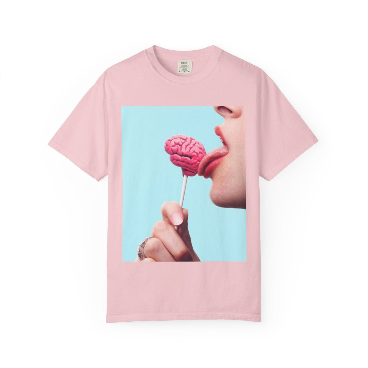Lickin Brain T-Shirt in Blossom with a surreal print of a tongue licking a pink brain lollipop against a turquoise background.